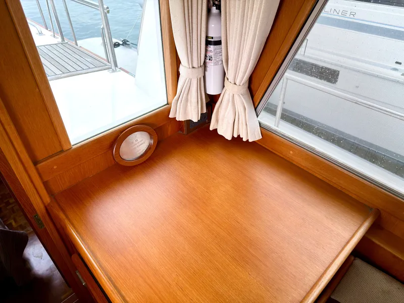 Slide: The Image of Interior of a 2003 Grand Banks Classic yacht with wooden table. - 21