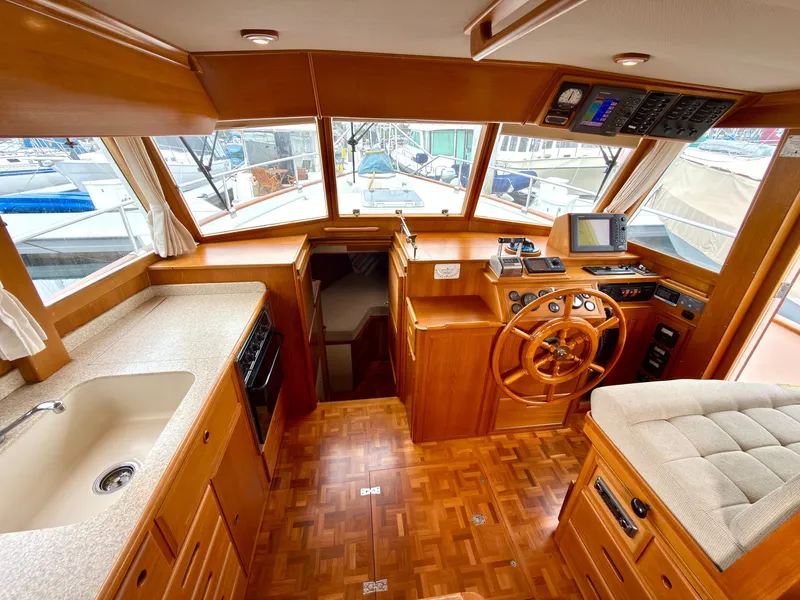 Slide: The Image of Interior of a 2003 Grand Banks Classic yacht with wooden finish. - 24