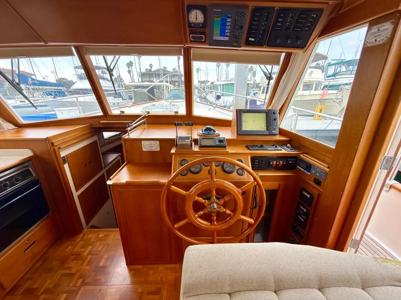 Slide: The Image of Interior of a 2003 Grand Banks Classic yacht with wooden helm. - 26