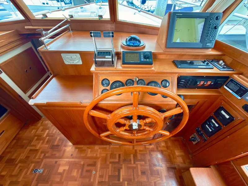 Slide: The Image of 2003 Grand Banks Classic yacht helm with wooden steering wheel. - 27