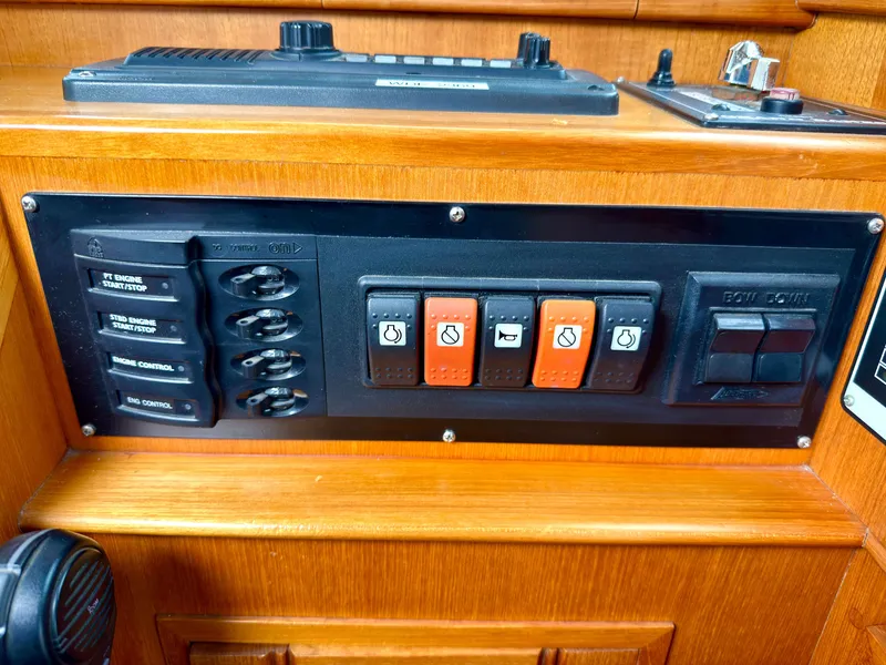 Slide: The Image of Control panel of a 2003 Grand Banks Classic with switches and controls. - 36