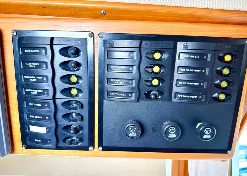 Slide: The Image of Control panel of a 2003 Grand Banks Classic with switches and indicators. - 37
