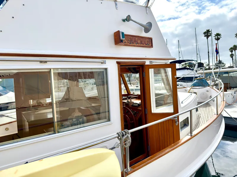 Slide: The Image of 2003 Grand Banks Classic yacht docked at marina, sunny day. - 4