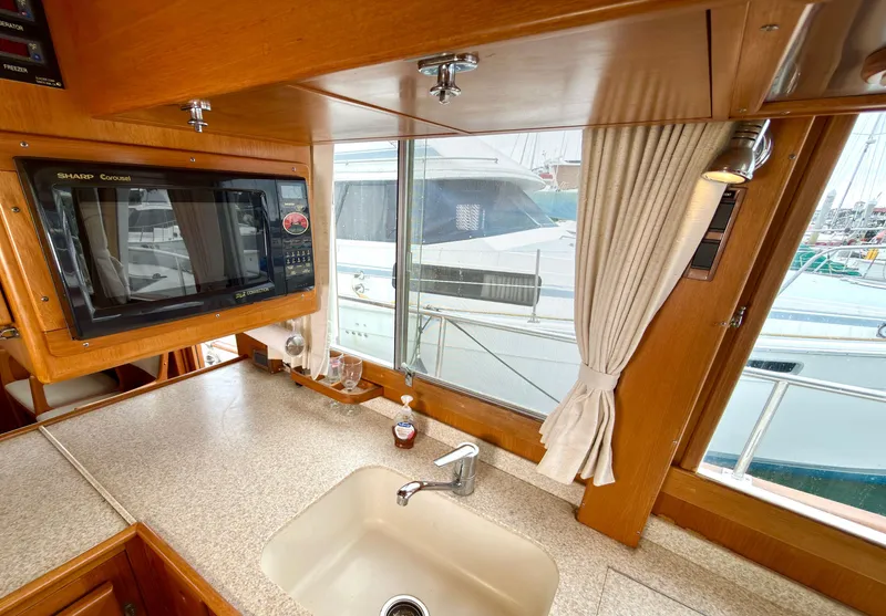Slide: The Image of Interior of a 2003 Grand Banks Classic yacht with kitchen and window view. - 46