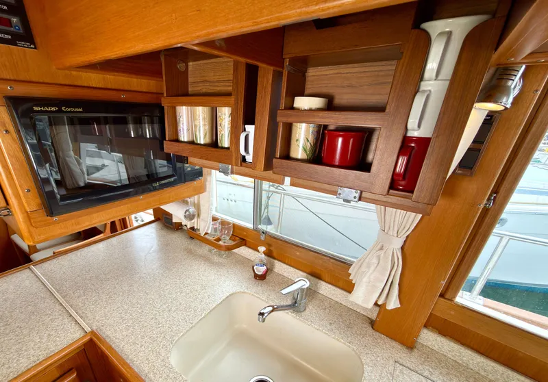 Slide: The Image of Interior of 2003 Grand Banks Classic with kitchen and microwave. - 47