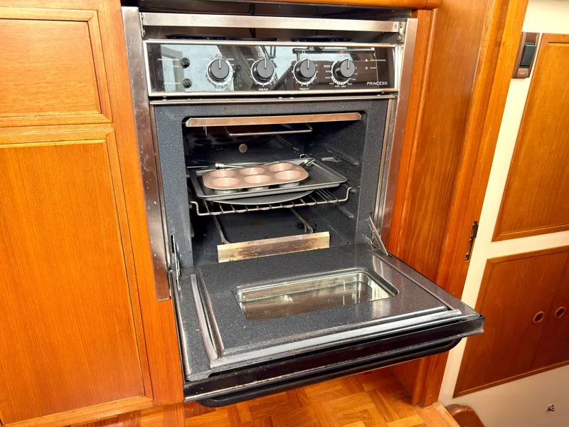 Slide: The Image of Open oven in a 2003 Grand Banks Classic yacht kitchen. - 49