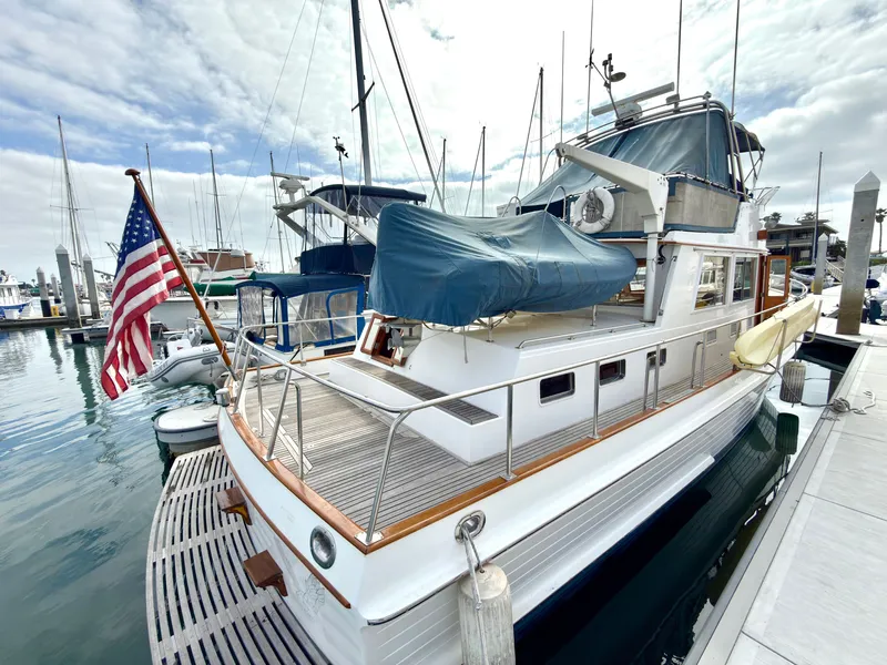 Slide: The Image of Grand Banks Classic 2003 yacht docked with American flag. - 6