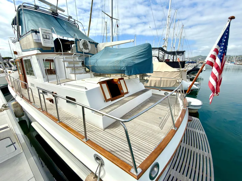 Slide: The Image of 2003 Grand Banks Classic yacht docked with American flag. - 7