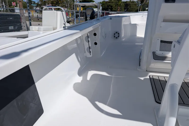 Slide: The Image of 2026 Tidewater 2410 Bay Max boat interior, showcasing sleek white deck and seating area. - 11