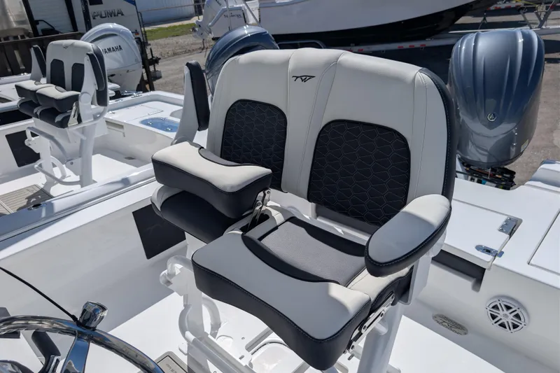 Slide: The Image of 2026 Tidewater 2410 Bay Max boat with dual cushioned seats and Yamaha engines. - 9