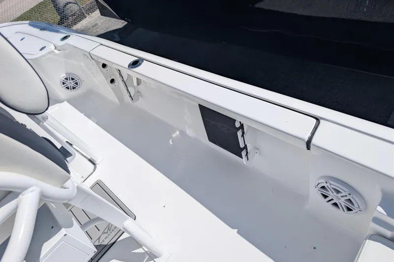 Slide: The Image of Interior view of 2026 Tidewater 2110 Bay Max boat, featuring seating and speakers. - 11