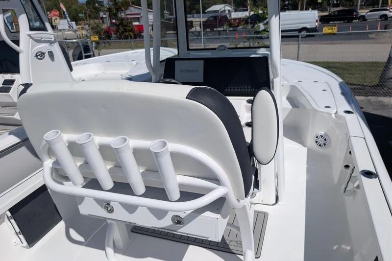 Slide: The Image of 2026 Tidewater 2110 Bay Max boat interior with rod holders and Garmin display. - 12