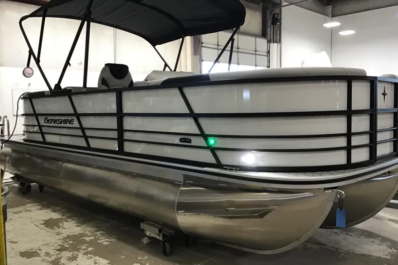 The Image of 2026 Berkshire 22RFX LE pontoon boat in a showroom, featuring sleek design and modern amenities. - 0