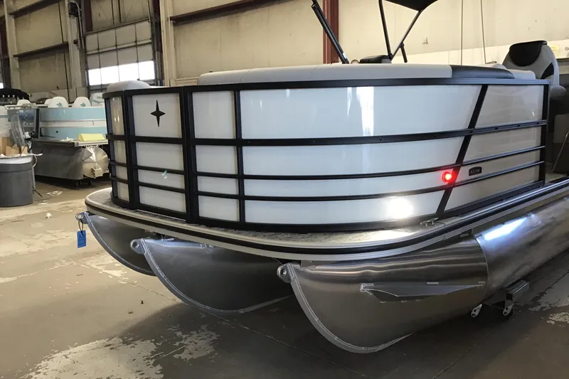 Slide: The Image of 2026 Berkshire 22RFX LE pontoon boat in a warehouse setting. - 2