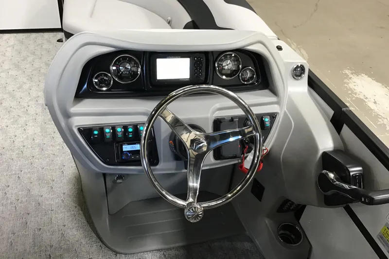 Slide: The Image of Steering console of 2026 Berkshire 22RFX LE boat with modern controls and gauges. - 3