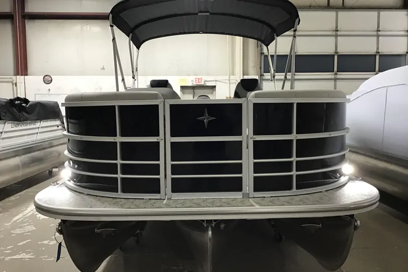 Slide: The Image of 2026 Berkshire 24RFX LE pontoon boat in indoor storage facility. - 2