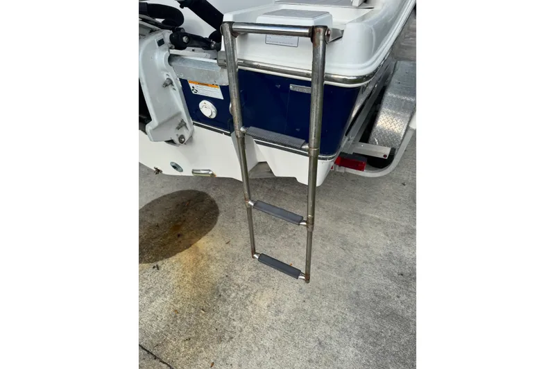 Slide: The Image of 2012 NauticStar 2500XS Offshore boat ladder on concrete surface. - 10