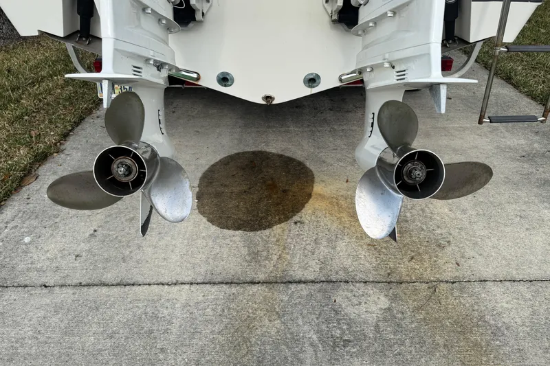 Slide: The Image of Twin propellers of a 2012 NauticStar 2500XS Offshore boat on concrete. - 11