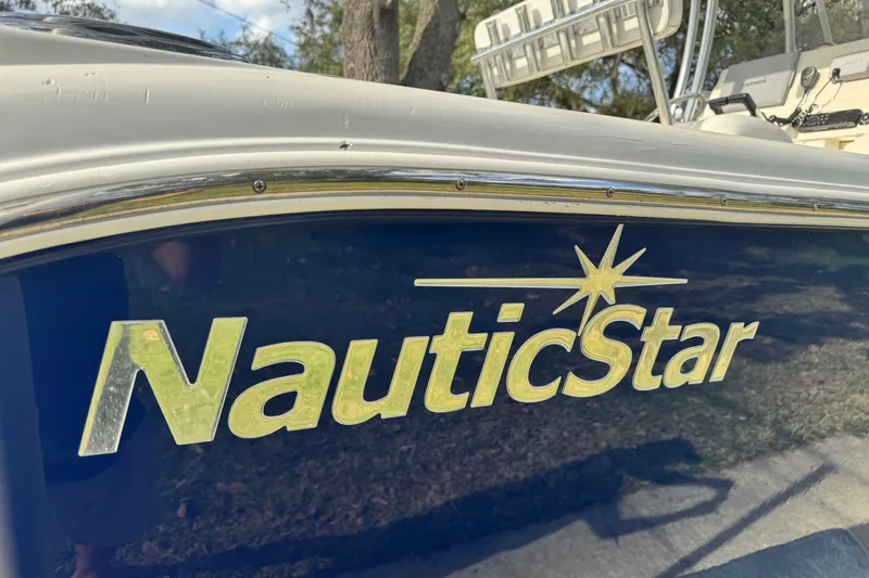 Slide: The Image of NauticStar 2500XS Offshore boat logo, 2012 model, close-up view. - 13