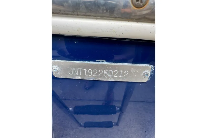 Slide: The Image of 2012 NauticStar 2500XS Offshore boat with visible hull identification number. - 14