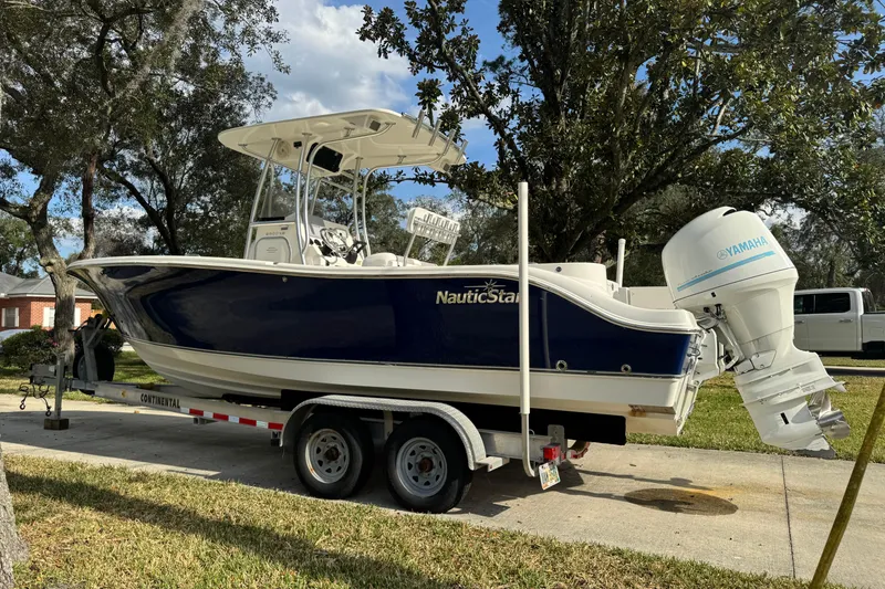 Slide: The Image of 2012 NauticStar 2500XS Offshore boat on trailer with Yamaha outboard motor. - 2