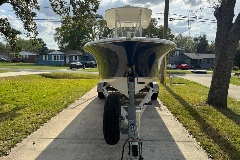 Slide: The Image of 2012 NauticStar 2500XS Offshore boat on trailer in suburban driveway. - 4