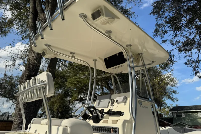 Slide: The Image of 2012 NauticStar 2500XS Offshore boat with T-top and rod holders under a clear sky. - 5