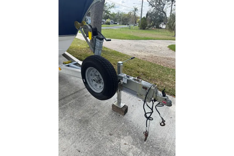 Slide: The Image of Trailer hitch and wheel of 2012 NauticStar 2500XS Offshore boat on concrete driveway. - 9