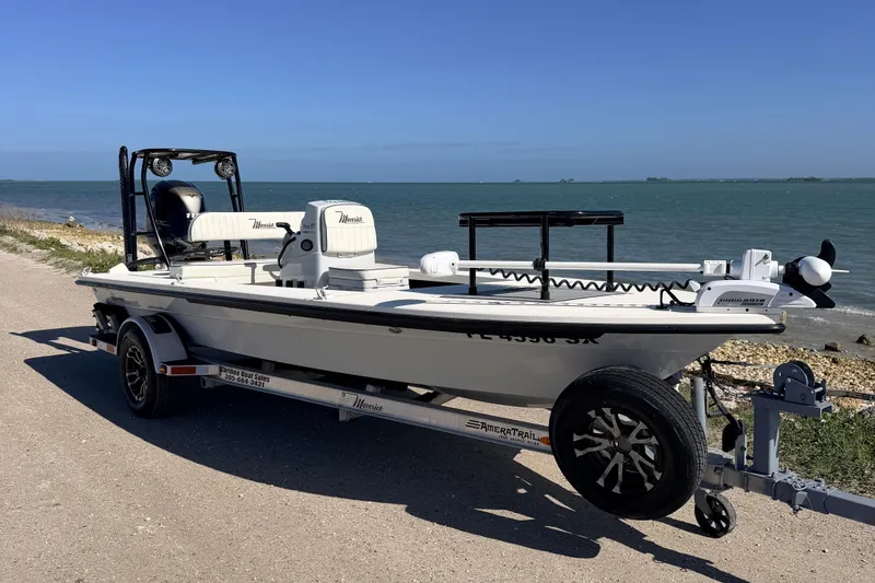 The Image of 2021 Maverick 18 HPX-V boat on trailer by the ocean, sunny day. - 0