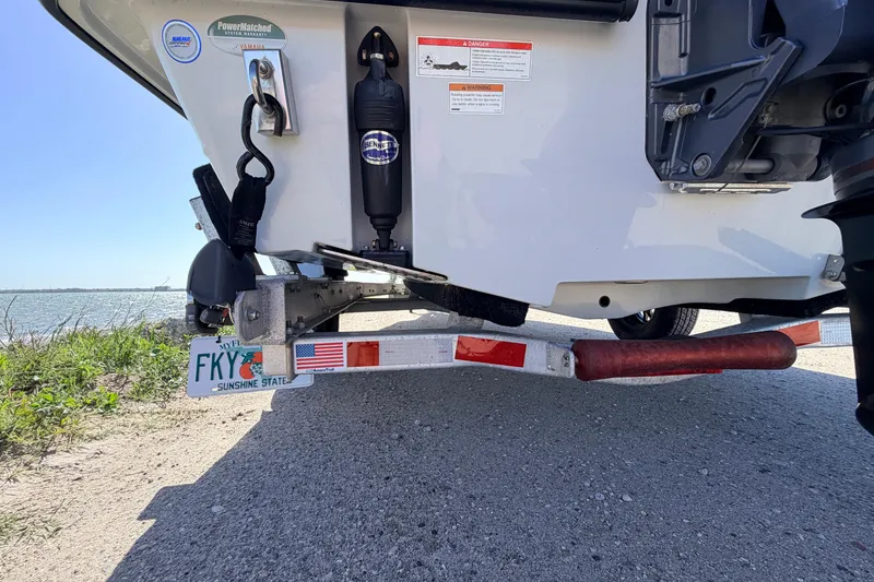 Slide: The Image of 2021 Maverick 18 HPX-V boat on trailer near water, featuring Florida license plate. - 10