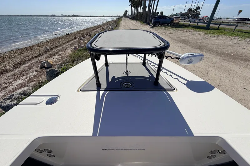 Slide: The Image of 2021 Maverick 18 HPX-V boat on coastal shoreline, featuring elevated platform and trolling motor. - 16