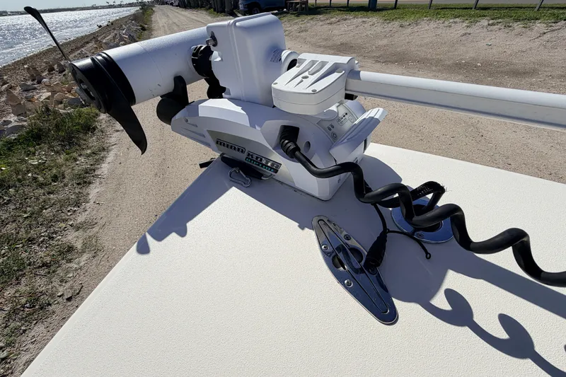 Slide: The Image of 2021 Maverick 18 HPX-V boat with mounted trolling motor by the shoreline. - 18