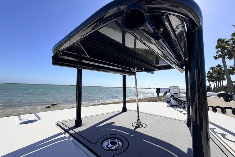 Slide: The Image of 2021 Maverick 18 HPX-V boat with T-top, near a scenic shoreline. - 19