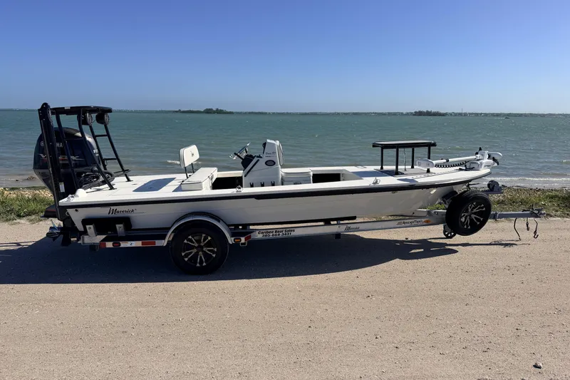 Slide: The Image of 2021 Maverick 18 HPX-V boat on trailer by the waterfront. - 2