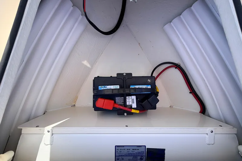 Slide: The Image of 2021 Maverick 18 HPX-V boat battery compartment with wiring and marine battery. - 21