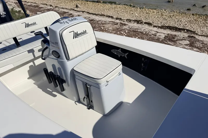 Slide: The Image of 2021 Maverick 18 HPX-V boat interior with seating and storage, near a rocky shoreline. - 22