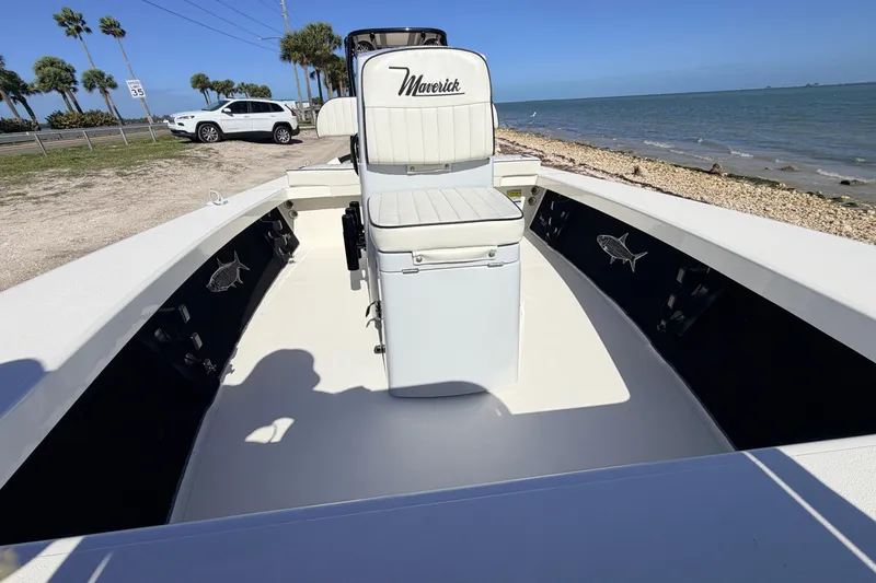 Slide: The Image of 2021 Maverick 18 HPX-V boat interior with seating, near a coastal shoreline. - 24