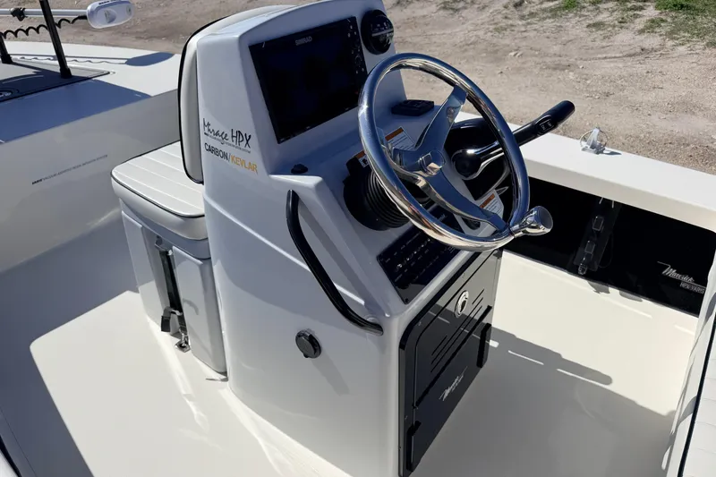 Slide: The Image of 2021 Maverick 18 HPX-V boat console with steering wheel and navigation controls. - 28