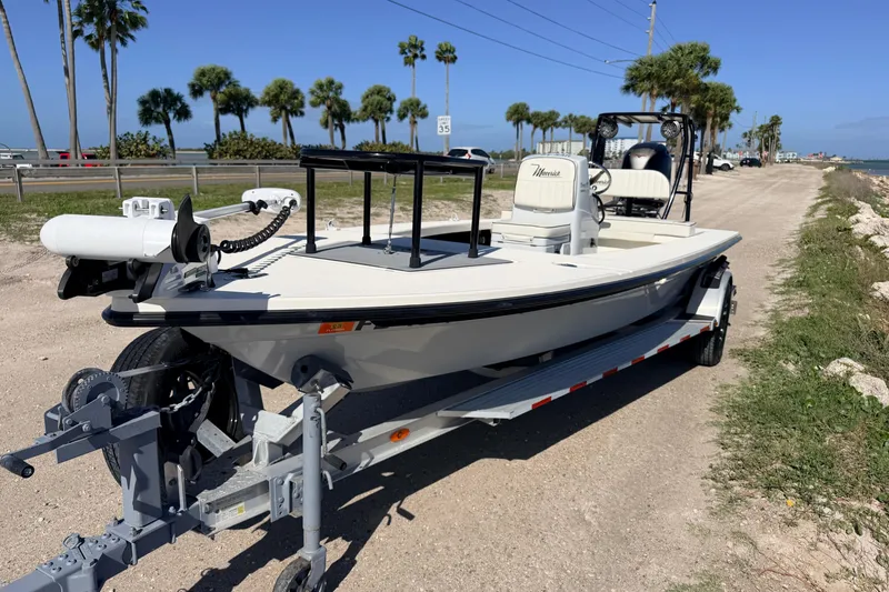 Slide: The Image of 2021 Maverick 18 HPX-V boat on trailer, parked near a coastal road with palm trees. - 3
