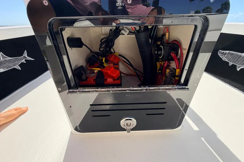 Slide: The Image of 2021 Maverick 18 HPX-V boat battery compartment with wiring and equipment. - 34