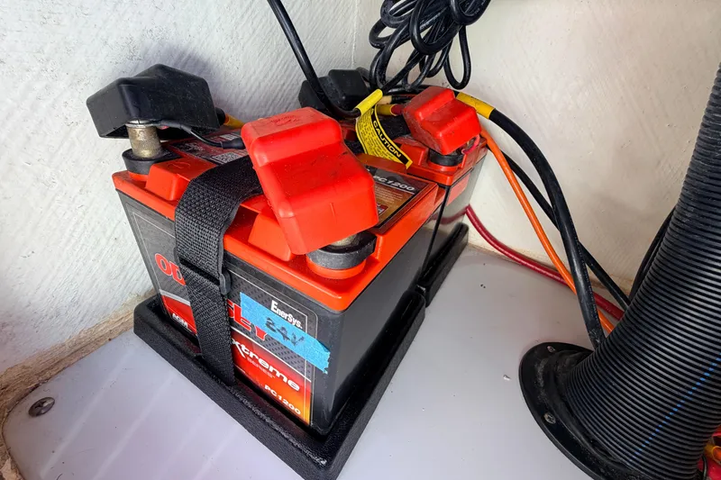 Slide: The Image of Battery setup in a 2021 Maverick 18 HPX-V boat, featuring secure connections and wiring. - 36