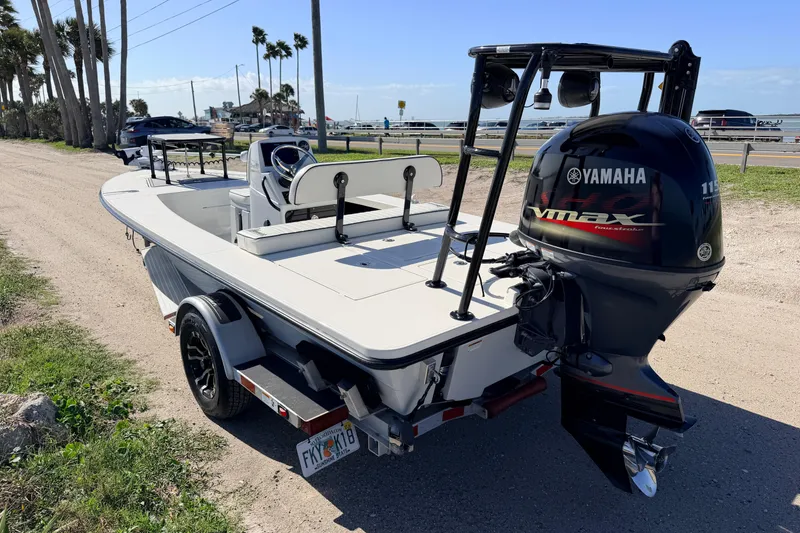 Slide: The Image of 2021 Maverick 18 HPX-V boat with Yamaha VMAX engine on a trailer by the coast. - 5
