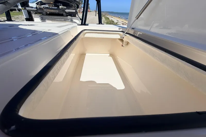 Slide: The Image of Open storage compartment of 2021 Maverick 18 HPX-V boat near the beach. - 50