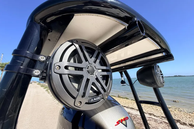 Slide: The Image of 2021 Maverick 18 HPX-V boat with JL Audio speakers, near a scenic shoreline. - 56