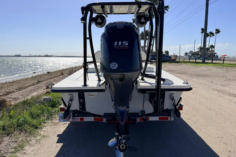 Slide: The Image of 2021 Maverick 18 HPX-V boat with Yamaha 115 engine by a scenic shoreline. - 6