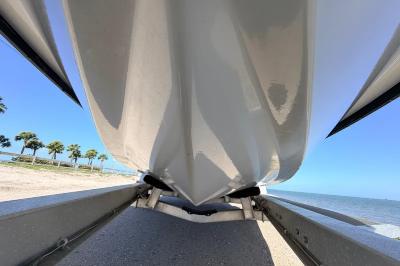 Slide: The Image of 2021 Maverick 18 HPX-V boat hull on trailer by the beach. - 9