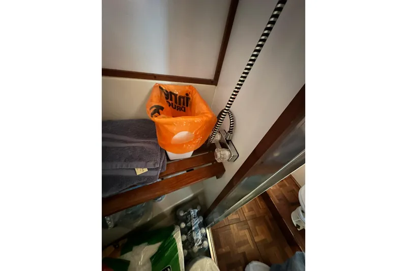 Slide: The Image of Interior of 1985 Carver 3207 Aft Cabin Motor Yacht with storage and orange bag. - 19