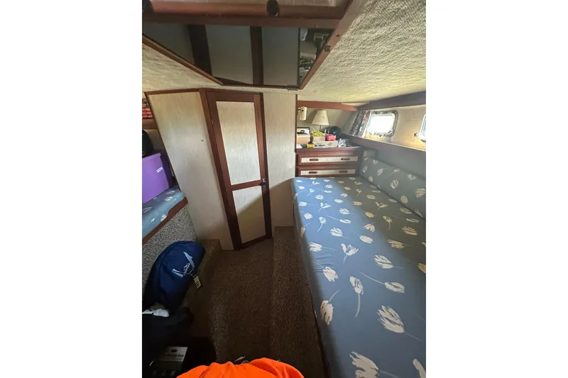 Slide: The Image of Interior of 1985 Carver 3207 Aft Cabin Motor Yacht with floral-patterned bedding. - 21