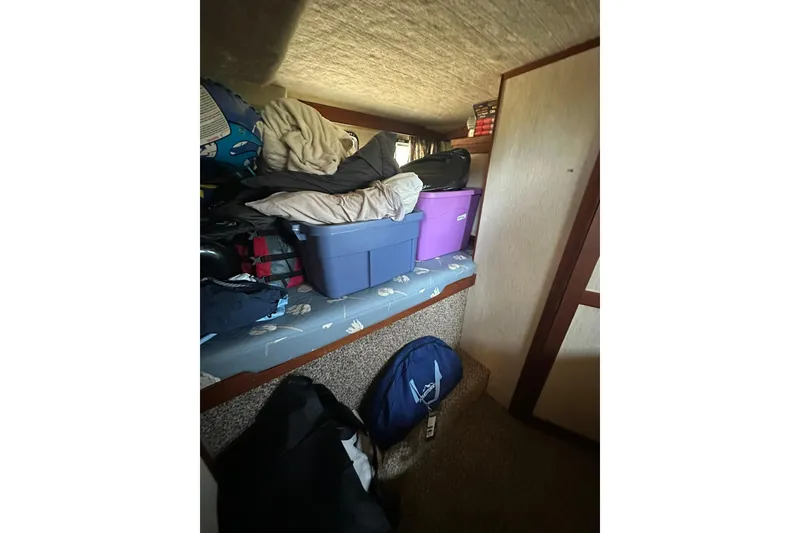 Slide: The Image of Interior storage area of 1985 Carver 3207 Aft Cabin Motor Yacht with bins and bags. - 22