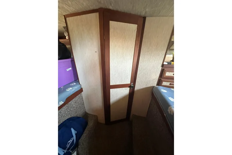 Slide: The Image of Interior of 1985 Carver 3207 Aft Cabin Motor Yacht with wooden door and cozy furnishings. - 23